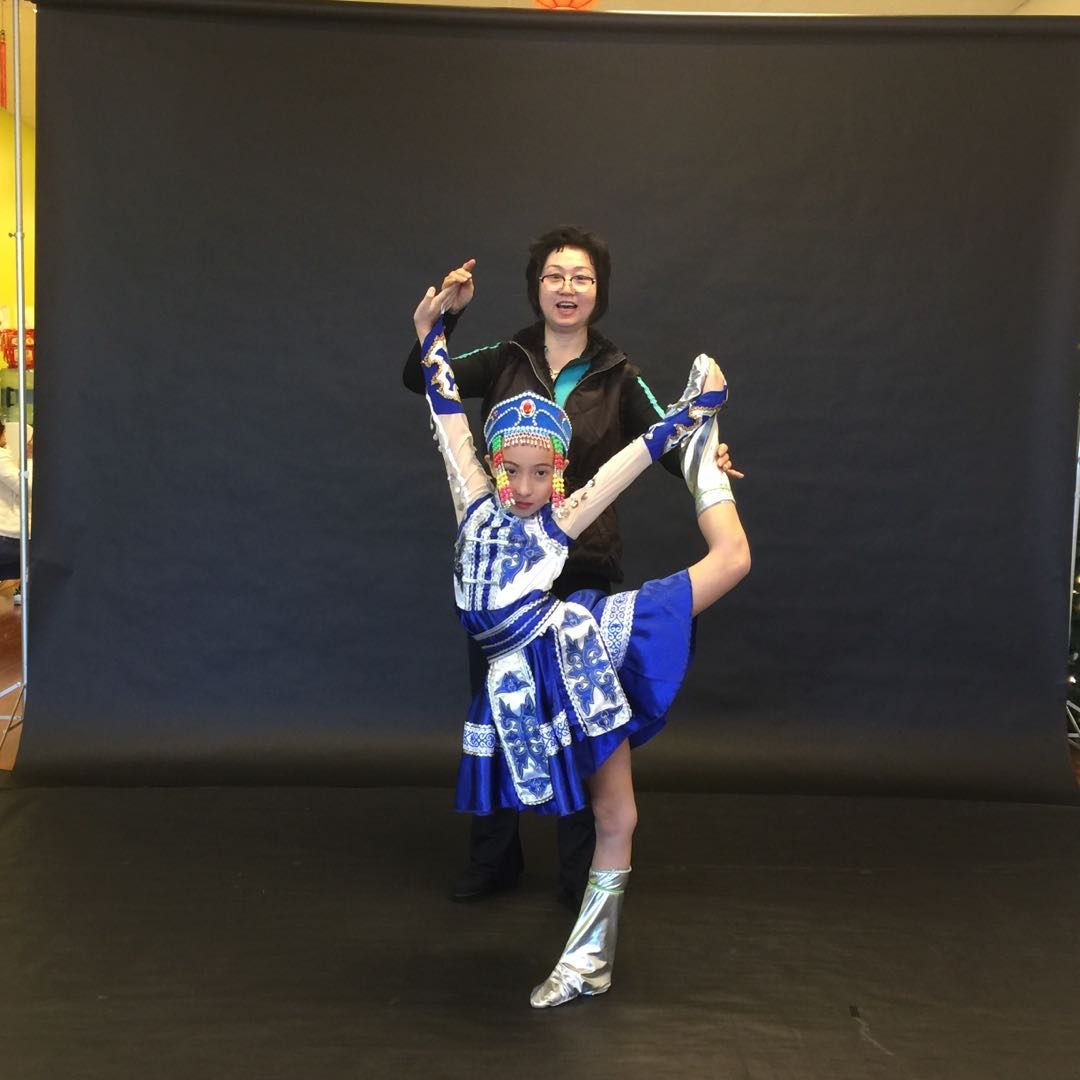 A dance teacher performing alongside a student