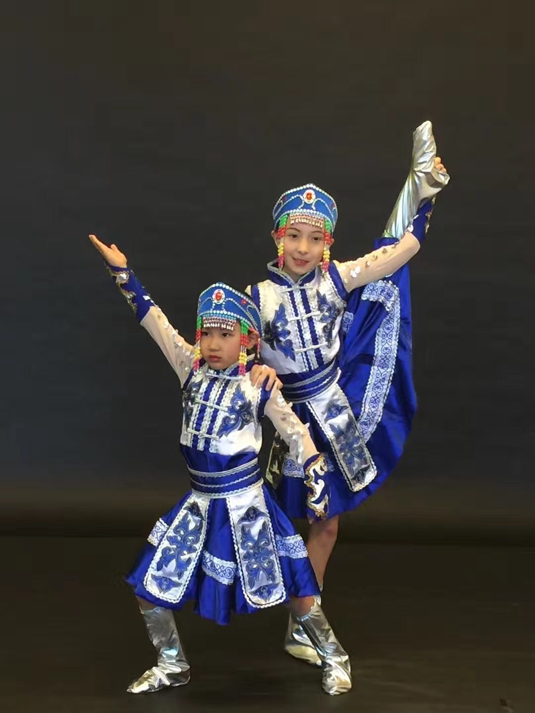 Three dance students performing in traditional costume